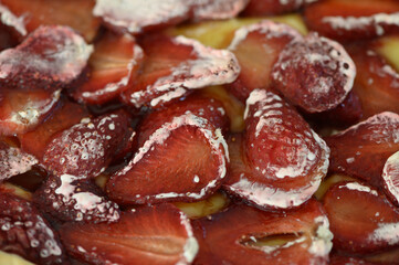 Layers of vibrant strawberries glistening with cream on a summery dessert delight at a garden gathering