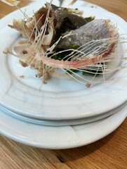 Fish bones lying on a plate after the meal