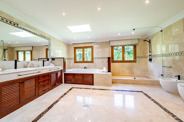an image of a large master bathroom with bathtub and shower in mediterranean mansion 