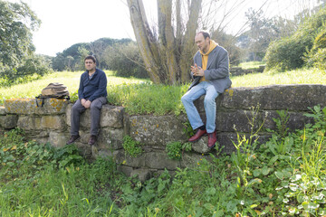 Two archaeologists resting on ancient roman ruins discussing recent findings
