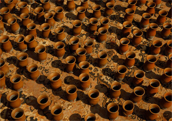 A background of claypots drying in th sunshine on a carpet