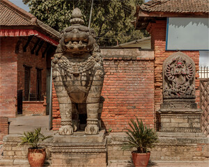 tone lion statue and Buddist Temple by the side of the school
