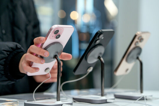 Showcase with smartphones in the electronics store. Buy a mobile phone. New Apple iPhones on the shelf of the store. A customer is choosing his next model. Minsk, Belarus - March 16, 2025
