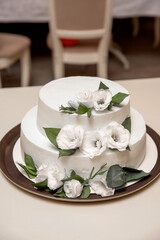 White wedding cake with flowers close-up