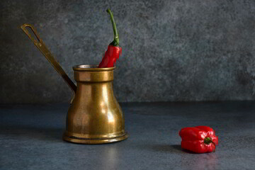 Old coffee pot and chilli pepper. It's an idea of chilli coffee.