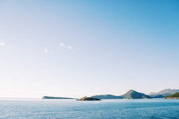 Mamula island with an old fortress against the backdrop of a mountain range. Montenegro