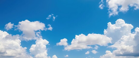 Fluffy white cumulus clouds scattered across a vibrant blue sky, texture, puffy