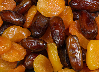 Close-up with dried dates and apricots. Dried fruits background