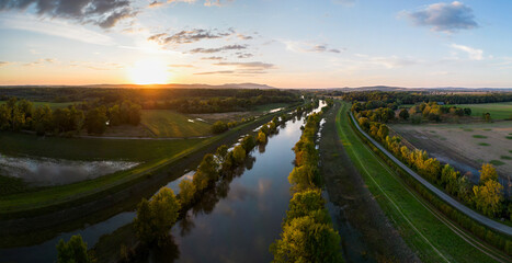 Obraz premium Sunset landscape panoramic drone aerial view autumn river Dyje sun trees meadow water reflection golden hour hill Palava horizon bird's eye view near Lednice Czech Republic