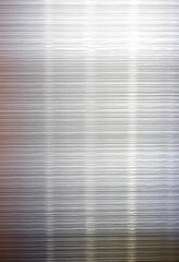 Close-up of brushed silver metallic surface showing texture and subtle highlights, grey, pattern