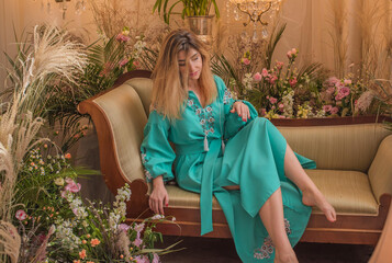 European Slavic woman posing in boho style turquoise dress. Concept of fashion. Hippie style and...