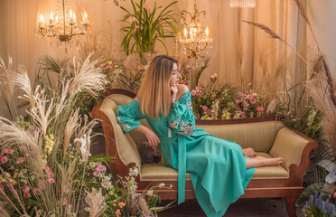 European Slavic woman posing in boho style turquoise dress. Concept of fashion. Hippie style and...