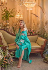 European Slavic woman posing in boho style turquoise dress. Concept of fashion. Hippie style and...