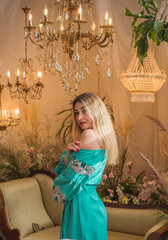 European Slavic woman posing in boho style turquoise dress. Concept of fashion. Hippie style and...