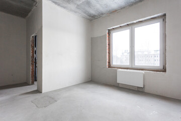 interior of the apartment without decoration in gray colors. rough finish