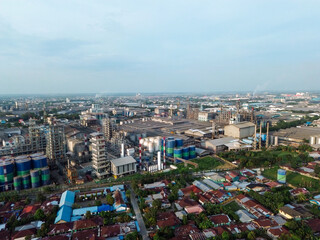 Obraz premium Aerial view of Medan Industrial Park, Indonesia, showcasing factories, highways, and urban development. Perfect for themes of industry, logistics, infrastructure, and economic growth