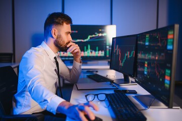 Crypto trader investor analyst looking at computer screen analyzing financial graph data