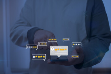 Online customer feedback and rating system. Person using a smartphone to interact with digital...