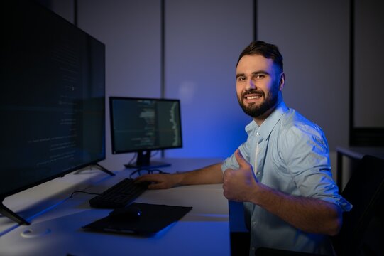Portrait of male programmer in office at night