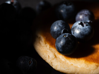 Ripe Blueberries on pancakes fruit macro close up
