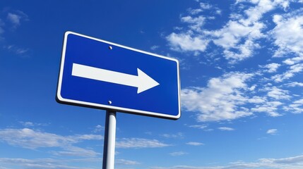 Blue arrow road sign with clear sky.