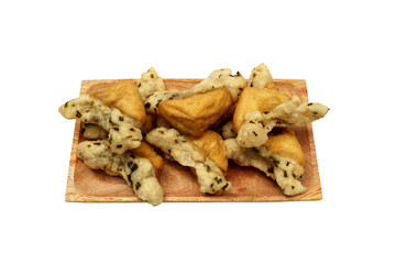 Tahu Aci or Tahu Kiwil or Tofu Aci is typical Tegal culinary dish made from tofu, Aci or Tapioca and spices and then fried until crispy. Served on wooden plate, Isolated on white background 