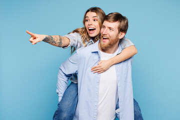 Young couple two friends family man woman wear shirt casual clothes together giving piggyback ride...