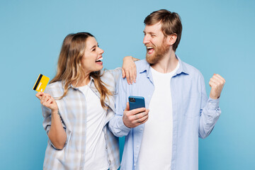 Young fun couple two friend family man woman wear shirt casual clothes together use mobile cell...