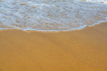 A sandy beach with gentle waves lapping at the shore can be a relaxing and peaceful place. This image is perfect for stock agencies and can be used in a variety of projects.