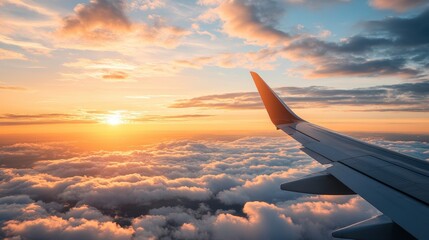 Obraz premium A Stunning Aerial View of a Vibrant Sunset with Golden Hues Over Fluffy Clouds from an Airplane Window Featu the Aircraft's Wing Viewpoint