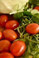Fresh ripe cherry tomatoes and lettuce on a cutting board