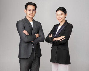 Business Professionals Standing Confidently in Formal Attire for a Studio Portrait.