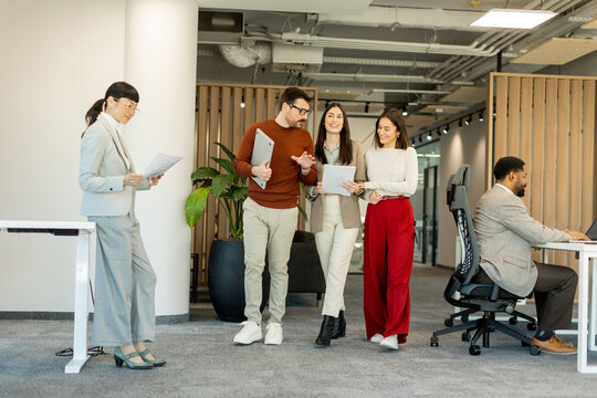 Collaborating in a modern office environment during a busy workday with creative discussions