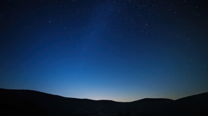 Fototapeta premium Stunning night landscape featuring the bright Milky Way galaxy over majestic mountains. A breathtaking starry sky perfect for nature, astronomy, and adventure themes.