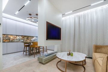 Stylish interior of the studio apartment. Exclusive kitchen decoration, exquisite furniture and original lamps.