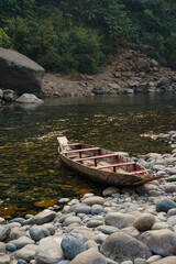 Wooden boat on the shore of a mountain river in Meghalaya, India