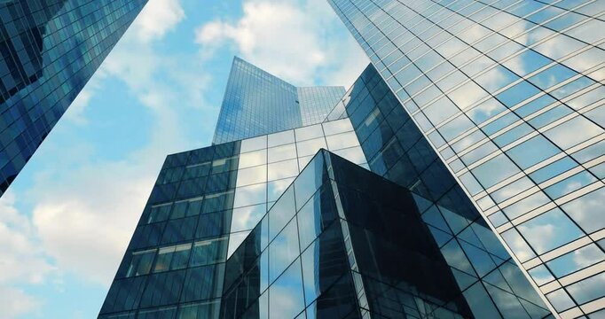 Timelapse Low angle view of skyscrapers in a bustling city, perfect for urban themes, architecture concepts, website backgrounds, and travel blogs.