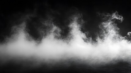 Obraz premium White smoke billowing against a black background.