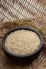 unhulled asian brown rice grains in rustic setting display in Cambodia