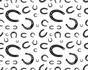 Seamless pattern with silhouettes of horseshoes on a white background
