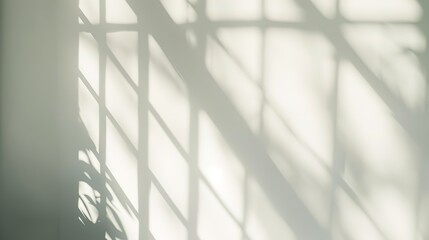 Window shadow reflections on a neutral wall, creating an abstract pattern with a minimalist and modern aesthetic for creative backgrounds.