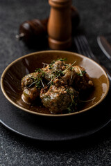 A beautifully arranged plate features expertly prepared European cuisine, highlighting the intricate details of the dish. Fresh herbs garnish the meal, enhancing its visual appeal