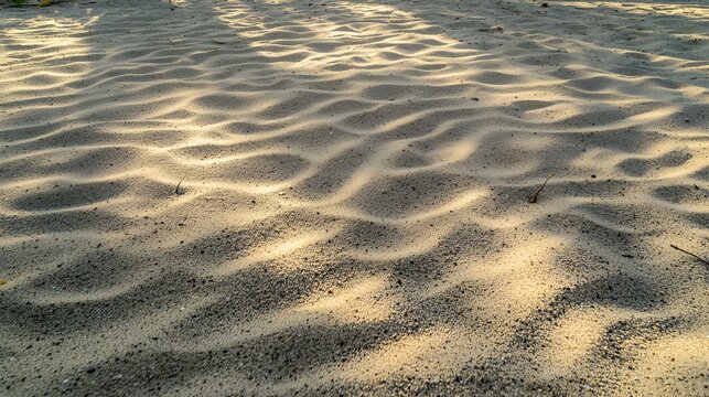 Sunlit beach sand texture, showing natural ripples and shadows.  Perfect for backgrounds or textures.