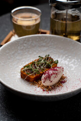 In a refined dining setting, a carefully presented dish showcases a rich blend of flavors