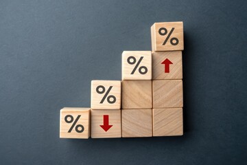 The image features wooden blocks arranged in a staircase pattern, displaying percentage symbols and arrows indicating upward and downward trends.