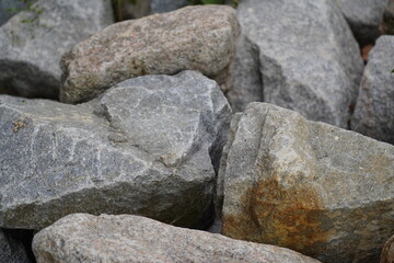 Granite is a coarse-grained igneous rock composed mainly of quartz, feldspar, and mica. It forms from the slow cooling of magma beneath the Earth's surface and is one of the most durable and widely us