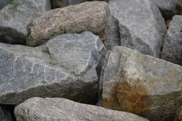 Granite is a coarse-grained igneous rock composed mainly of quartz, feldspar, and mica. It forms from the slow cooling of magma beneath the Earth's surface and is one of the most durable and widely us