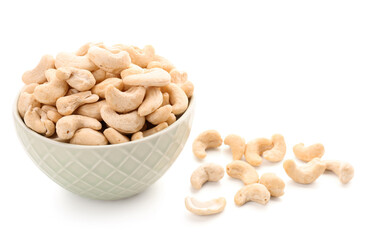 Bowl with tasty cashew nuts isolated on white background