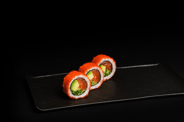 Delicious Fresh Salmon Sushi Rolls Presenting Exquisitely on a Black Background