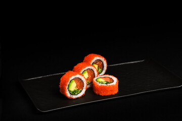 Delicious Fresh Salmon Sushi Rolls Presenting Exquisitely on a Black Background